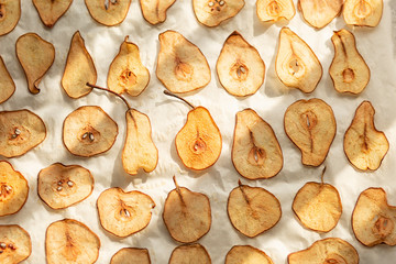 Sweet pear chips. Healthy fruit snack. We bite the chips in the oven from the pear. Vegetarian food. Dessert