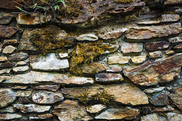 Stone wall with green moss background.