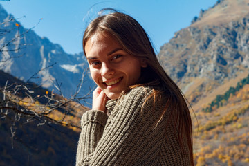 portrait of a girl against the backdrop of mountains