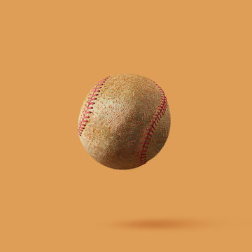 Baseball ball made from kiwi isolated on light brown background