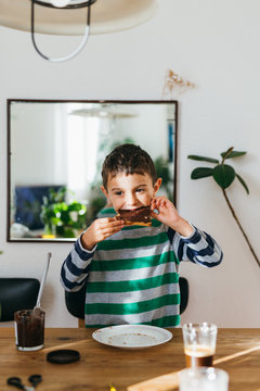 Kid eating bread with chocolate