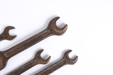 Old rusty stainless steel crescent wrench isolated on white top view