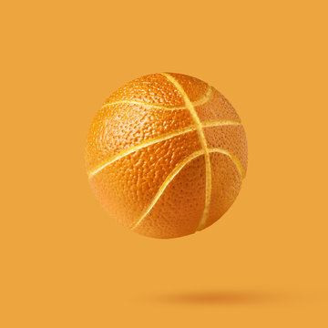 Orange basketball ball isolated on orange background with copy s