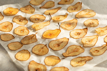 Sweet pear chips. Healthy fruit snack. We bite the chips in the oven from the pear. Vegetarian...