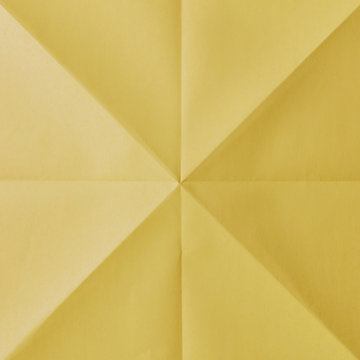 Close up of folded yellow origami paper