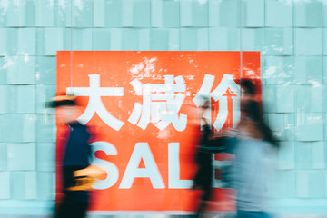 people walking with discount sale sign in China