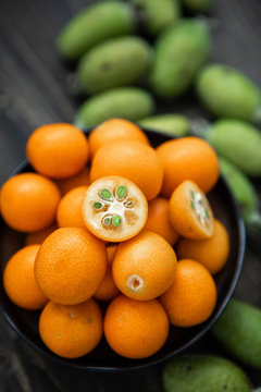 Close Up Of Bowl Of Kumquats and Feijoa Fruit