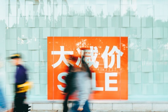 people walking with discount sale sign in China