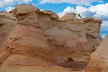 Ojito Wilderness low angle landscape of large yellow striped rock formation 