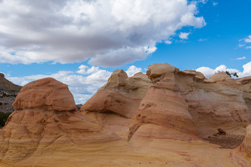 Ojito Wilderness low angle landscape of large yellow striped rock formation 