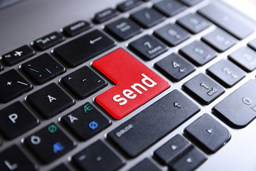 Close-up view on conceptual notebook keyboard - send(red key,button)