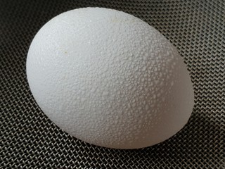 An egg on black background