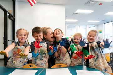 Elementary School Students Making Paint Handprints