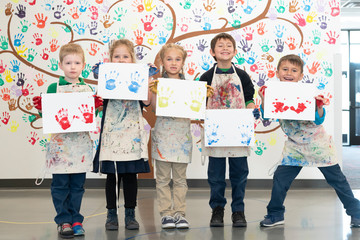 Elementary School Students Making Paint Handprints