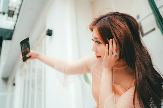 Chinese woman selfie using a cell phone