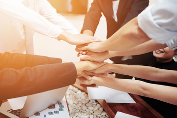 Close up  of young business people putting  hands for success project 