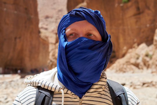 Portrait, traveler with a tied blue berber tagelmust scarf, Atlas mountains, Morocco.       