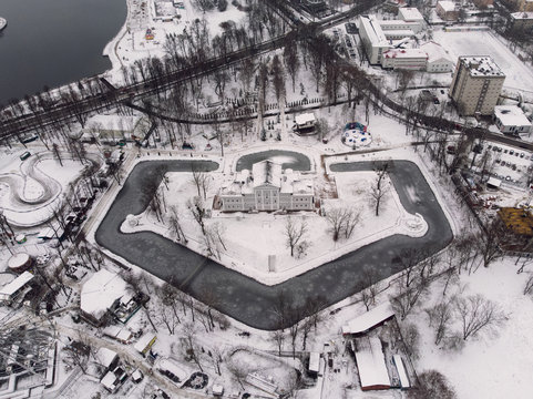 Picturesque view of old building near river between winter city