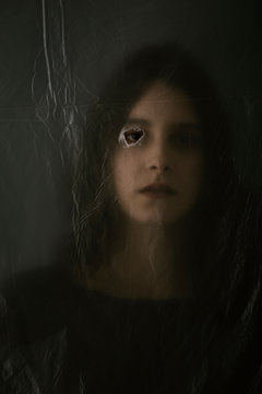 Woman behind blurry plastic