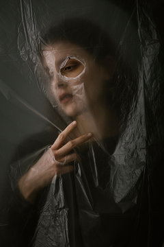 Woman behind blurry plastic