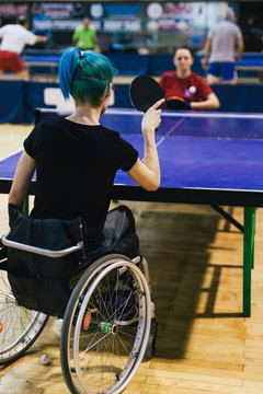 Woman in wheelchair playing table tennis