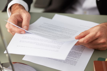 Formal man with paper documents
