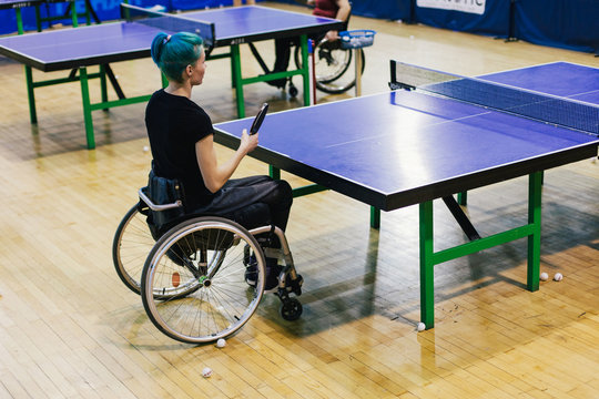 Woman in wheelchair playing table tennis