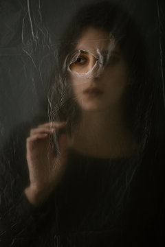 Woman behind blurry plastic