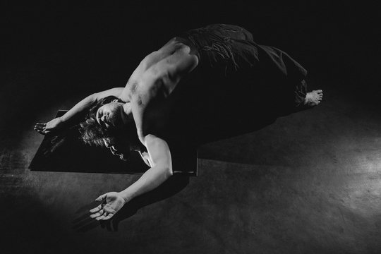 A man lying over the mirror.
