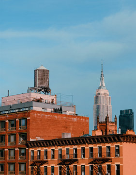 brick building and empyre state building in new york city