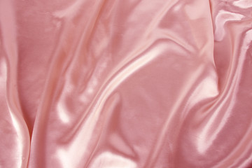 soft folds on delicate pink shiny silk, luxury concept, background for the designer, horizontal, close-up, copy space