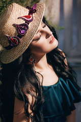 Portrait of beautiful brunette woman  with makeup in hat