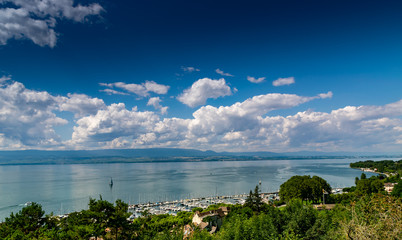 View from the viewpoint of the port of Thonon les Bains, boats, Lake Geneva, and the blue sky with clouds.Haute-Savoie in France.