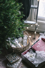 Christmas tree decorations. Holiday season. Christmas tree ornaments in silver and white colors. Festive colors of green, red and white.