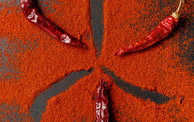 Fiery red pepper on a black background. View from above.