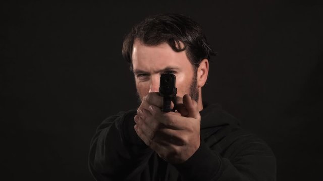 Man Shooting Pistol At Camera Black On Black