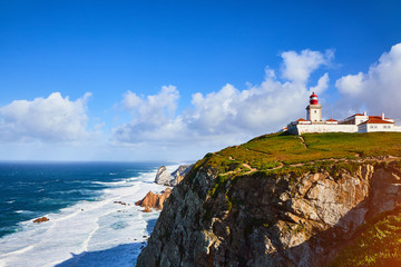 Fototapeta na wymiar Cabo da Roca, Portugal. Lighthouse and cliffs over Atlantic Ocean, the most westerly point of the European mainland.