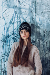 Portrait of beautiful young brunette woman with makeup in hat