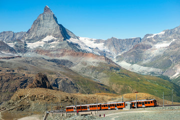 Obraz na płótnie Canvas red train on the background of Matterhorn peak in the Swiss Alps ( Pennine Alps )