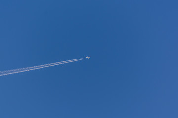 Airplane and vapour trail in the sky