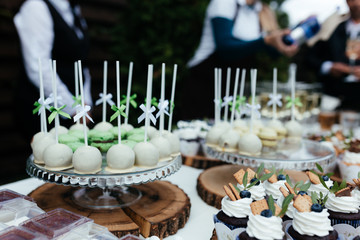 Lollypops and macaroons on the table during the wedding