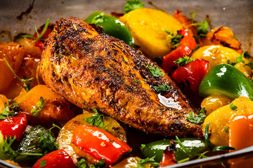 Roast chicken breast with potatoes and vegetables in pot