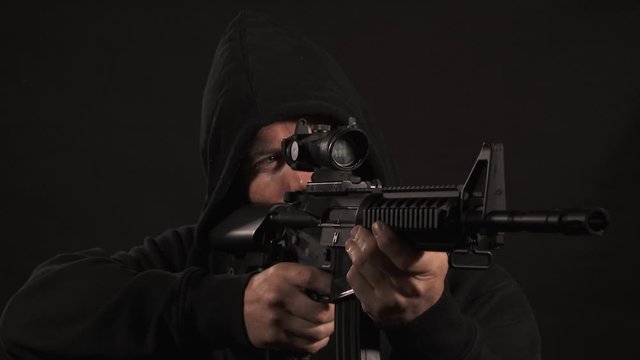 Man In Black Hoodie With Machine Gun
