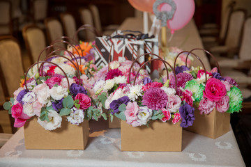 Paper bouquet of fresh red, white , blue, purple roses . Paper bouquet of multicolored roses . Pink, red flower picture close up in the bouquet colorful flower bouquets on paper bouquets .