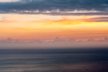 Landscape photography in which a winter sunrise is seen in the Mediterranean Sea from the coast of Alicante. Ideal for backgrounds. Space for text and presentations.