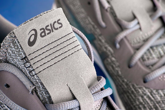 Tambov, Russian Federation - April 16, 2019 Close-up of new gray Asics running shoes.