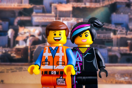 Tambov, Russian Federation - February 24, 2019 Lego Hard Hat Emmet and Lucy minifigures against Apocalypseburg background. The Lego Movie 2