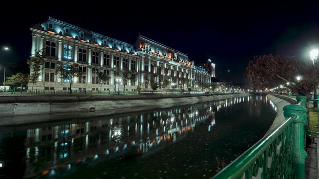 Bucharest, Romania - October 30th 2019: Time lapse at the Dambovita river in Bucharest on a clear night.
