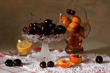 Summer fruit plate with black cherry and apricot, lemon close up