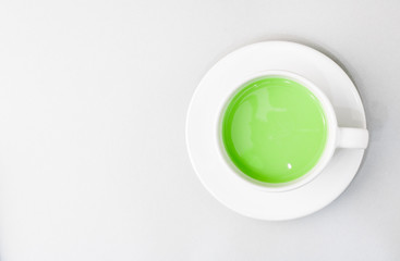 Top view of green tea matcha in a white mug. Matcha ginger latte. Rich source of antioxidants and polyphenols.
